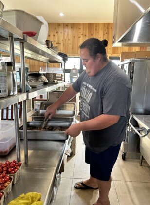 Photo: Kane works in the kitchen at Johnny's Market