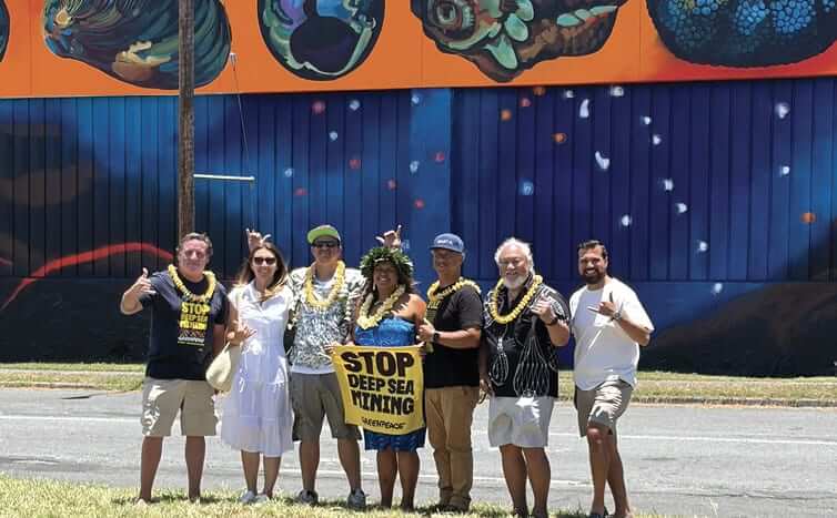 Photo: Greenpeace project lead poses with mural project managers, artists and activists