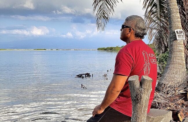 Photo: Laʻa Poepoe looks out over the ocean at Kūpeke Fishpond