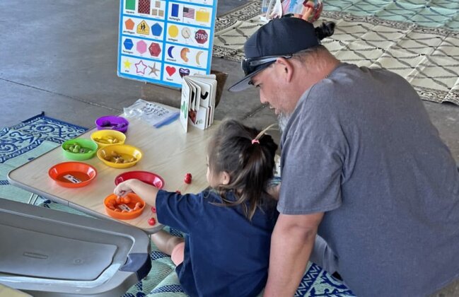 Photo: Keiki and her father working on a math activity