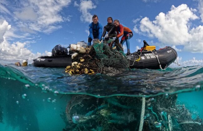 Photo: NOAA teams pull fishing nets out of the ocean