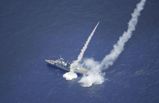 Photo: Royal Canadian Navy ship HMCS Regina (FFH 334) fires two Harpoon Surface to Surface Missiles as part of Exercise Rim of the Pacific