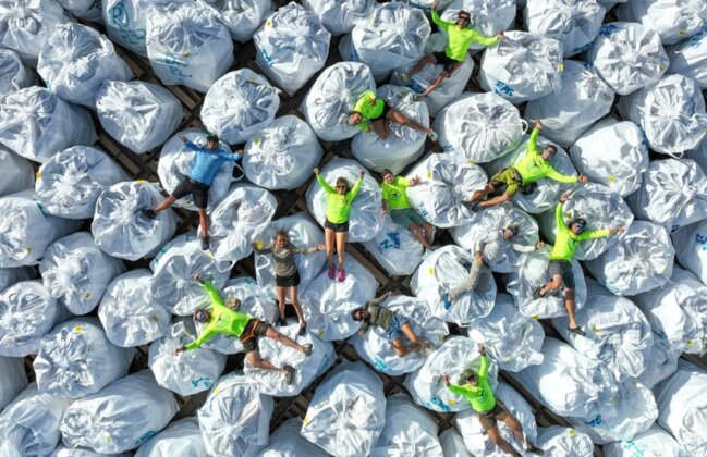 Photo: Papahānaumokuākea Marine Debris Project staff celebrate on a large pile of marine debris
