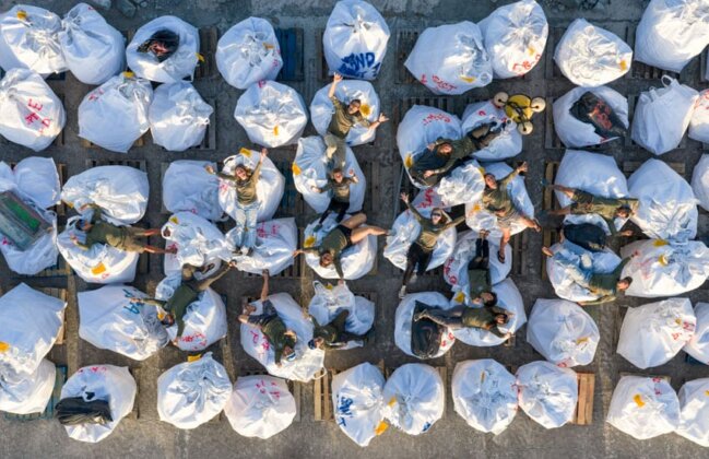 Photo: Papahānaumokuākea Marine Debris Project staff celebrate on a large pile of marine debris