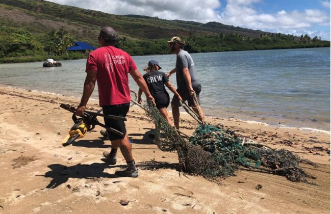 Photo: Volunteers remove ghost nets from the beach